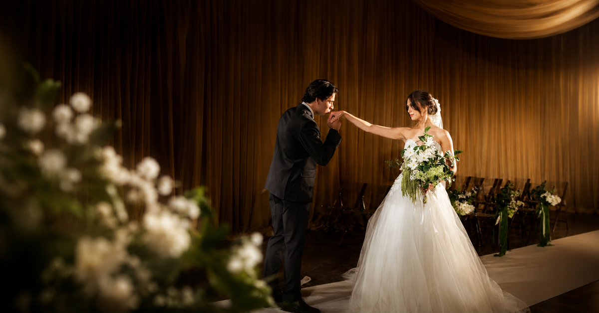 Bride and groom celebrating at FE Wedding Chapel with green and white flowers